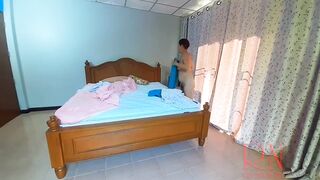 Nudist housekeeper Regina Noir makes the bedding in the bedroom. Naked maid. Naked housewife. c2