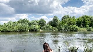 Russian girl bathing naked in countryside river